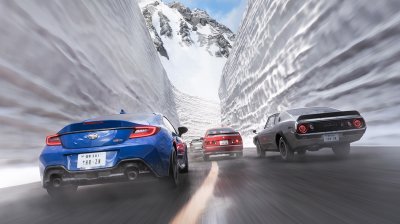 Three cars pushing flat out through an icy mountain section as snow kicks up across the road.
