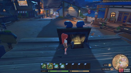 There is a chest behind the sign on the roof of the stable