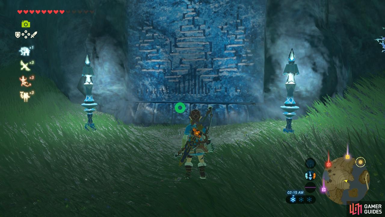 The monument is surrounded by grass and is at the lake's shore