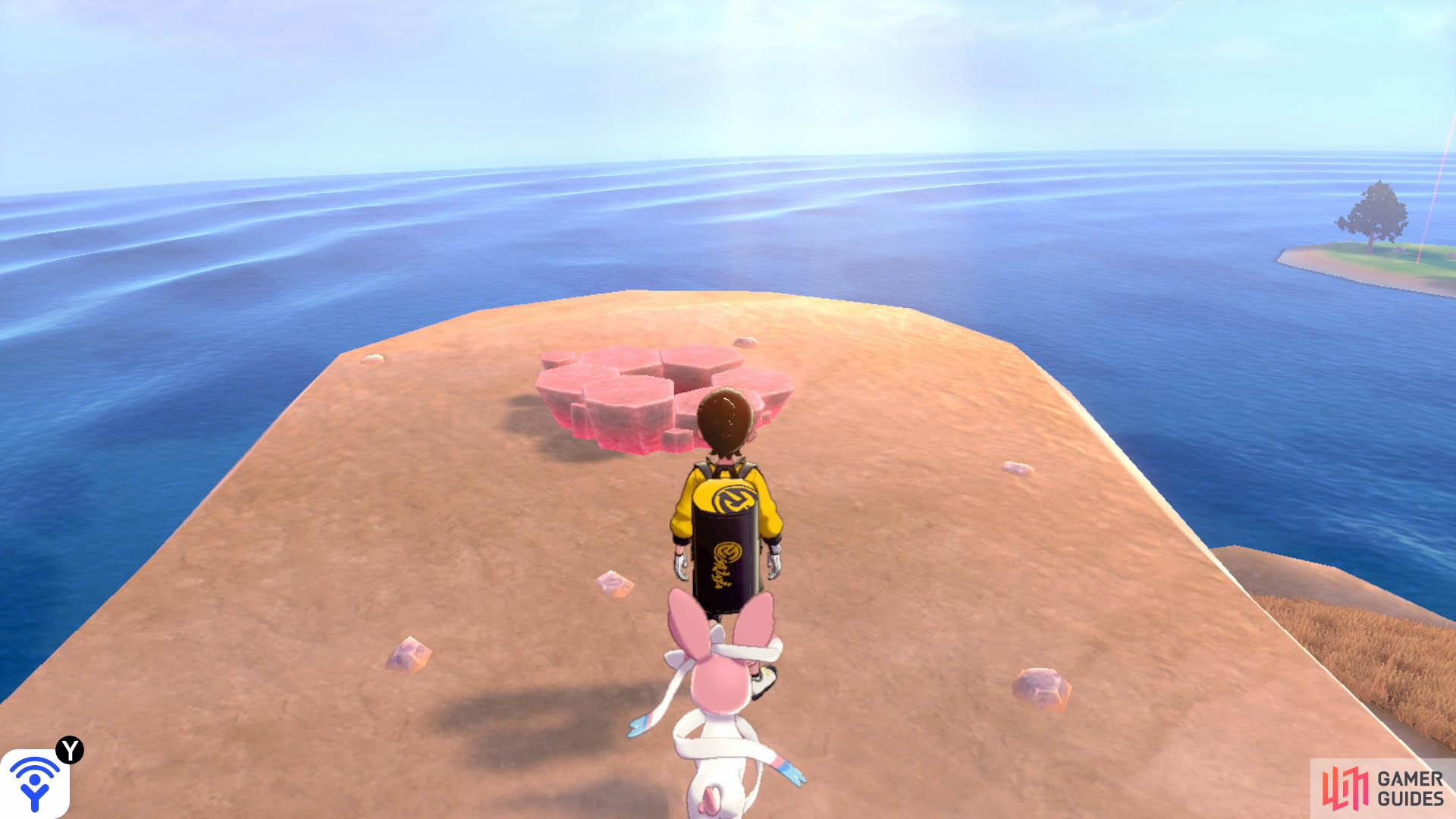 At the second crossroad, turn right while facing the stairs to the tower. At the edge of the plateau, overlooking the ocean. There are pebbles nearby.