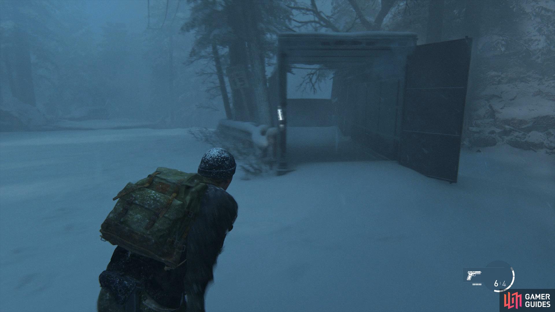 Head through the container and follow the path along until you reach a large area full of crates