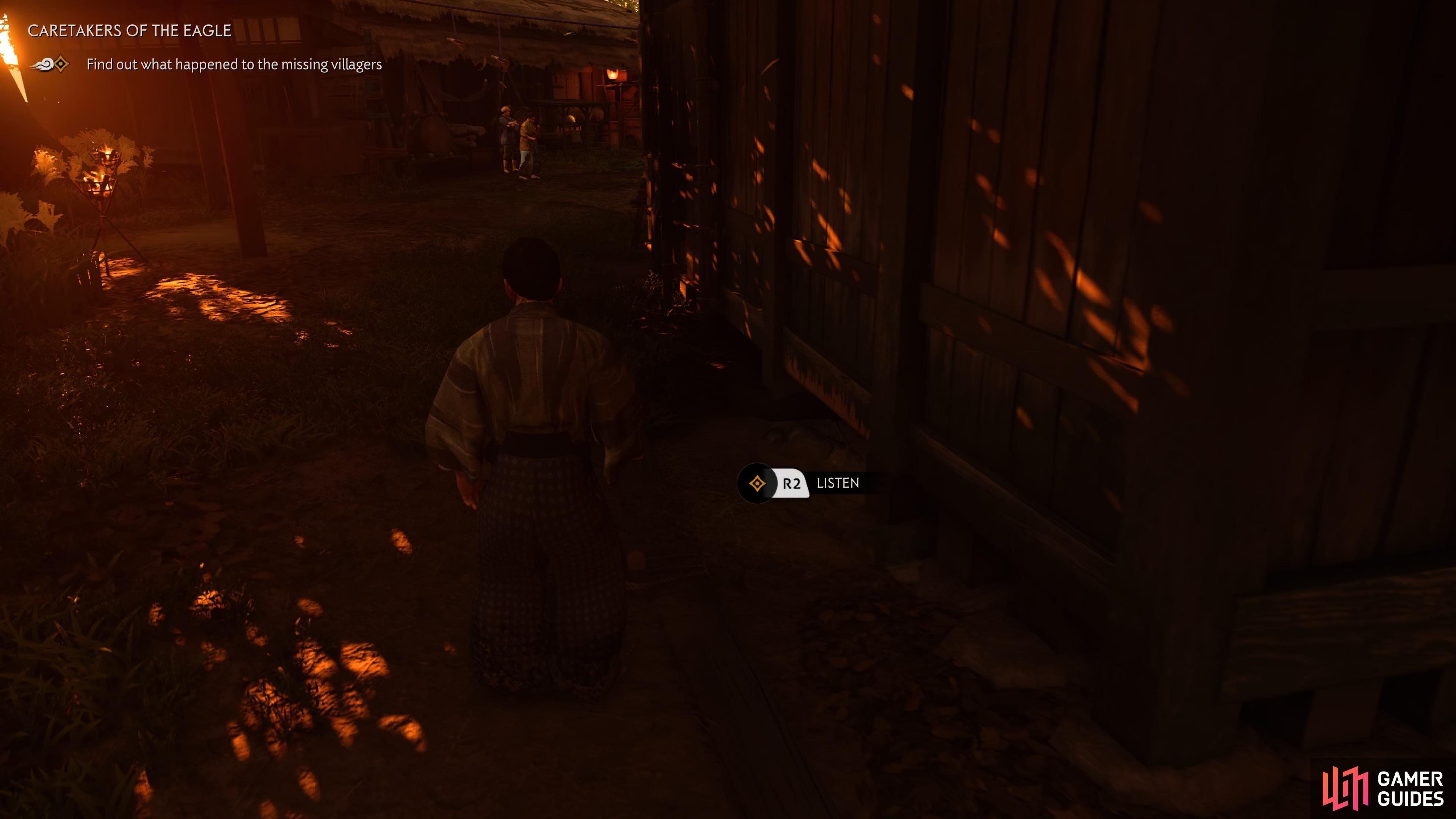 head to the side of this building to listen in on the captive villagers.