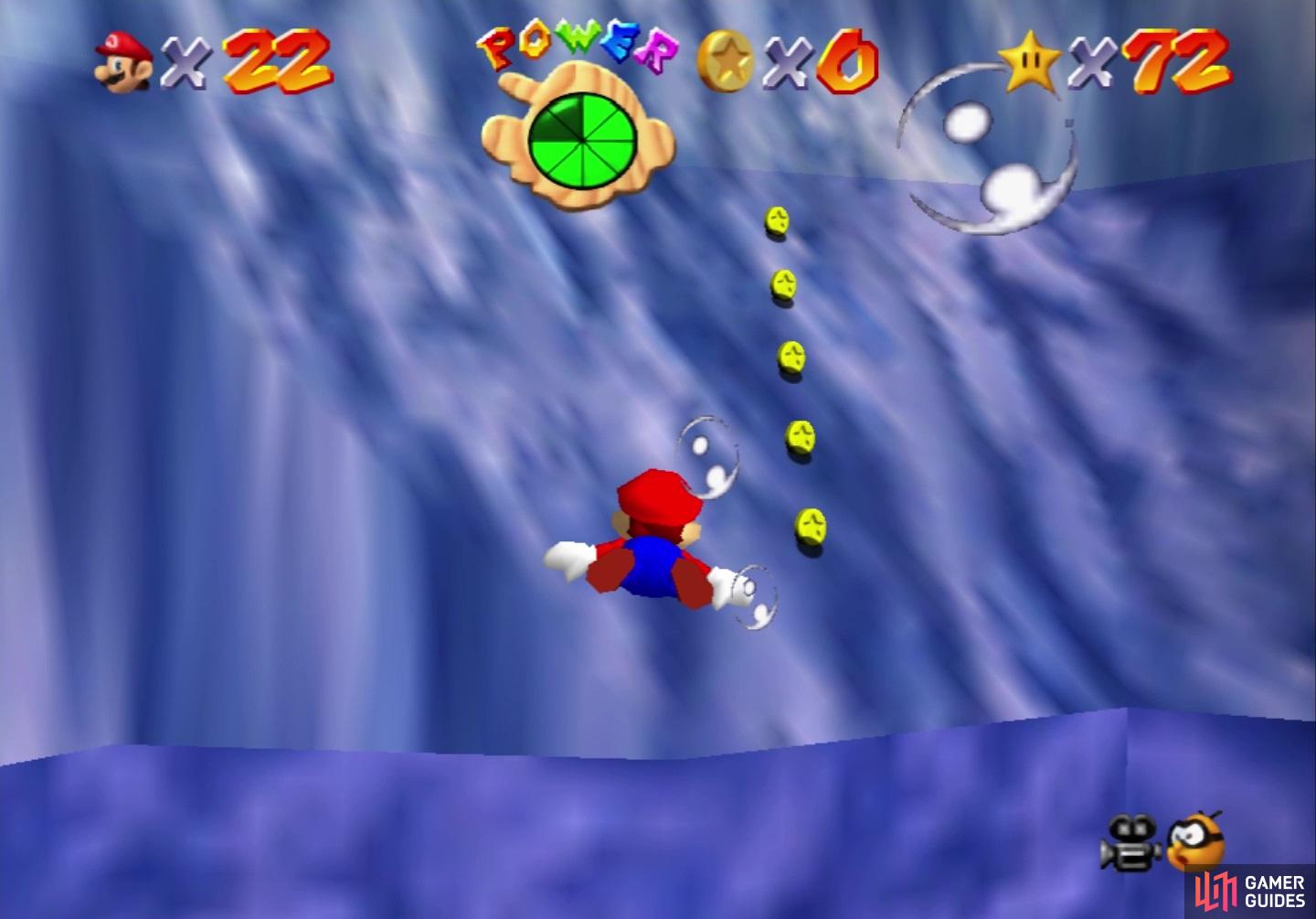 There are five coins located on a slope near the top of the first area
