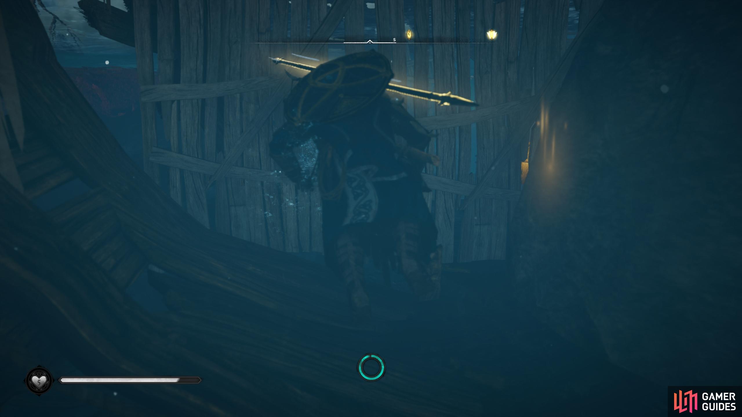 Break the wooden barrier to access the chest in the shipwreck beneath the water.