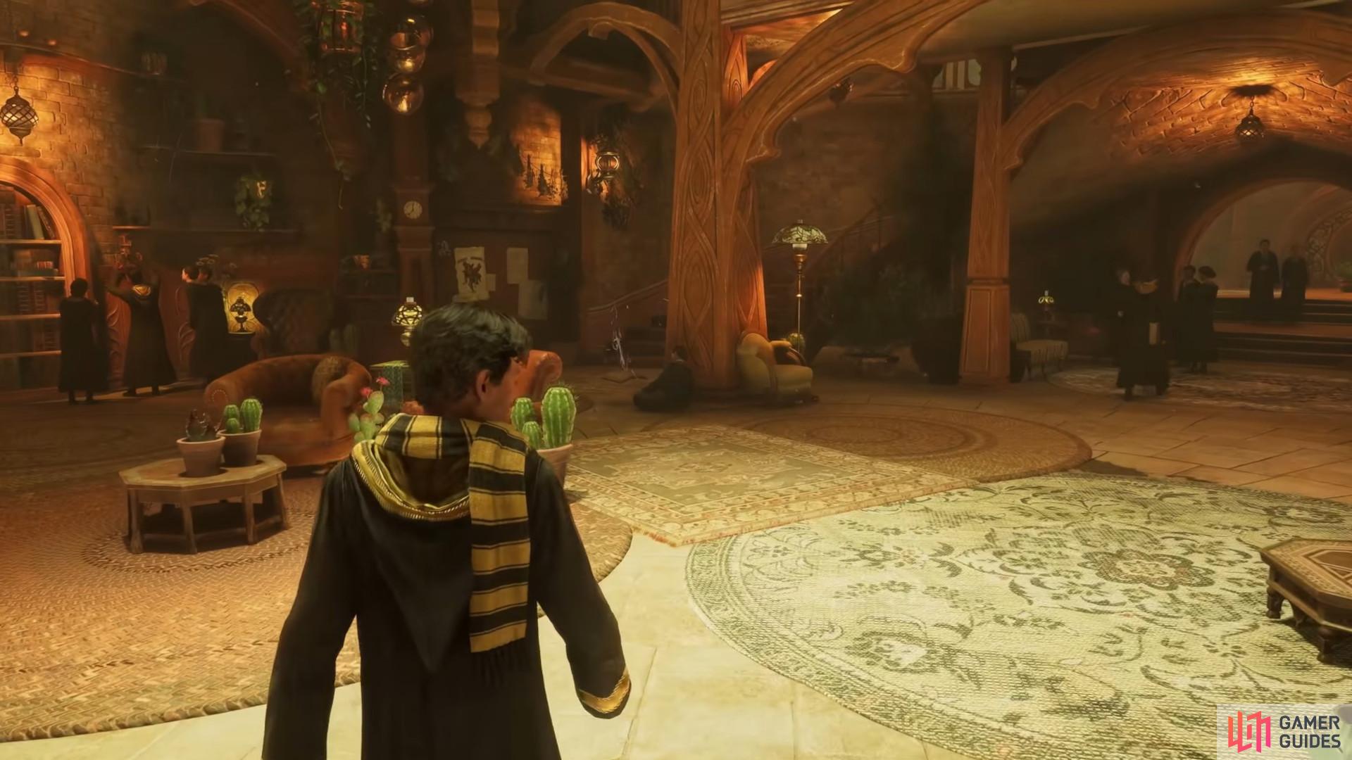 The Hogwarts Legacy Hufflepuff Common Room has a gilded and plant aesthetic. Image via Warner Brothers.