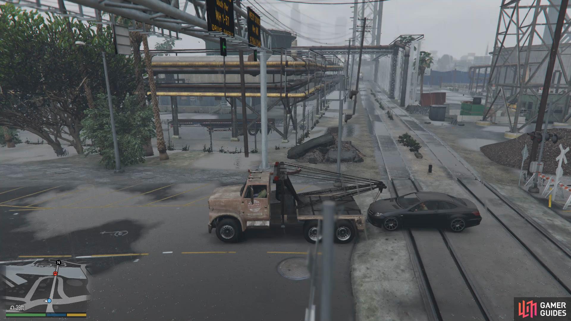 Quickly hook up the car and take off the tracks before the train passes