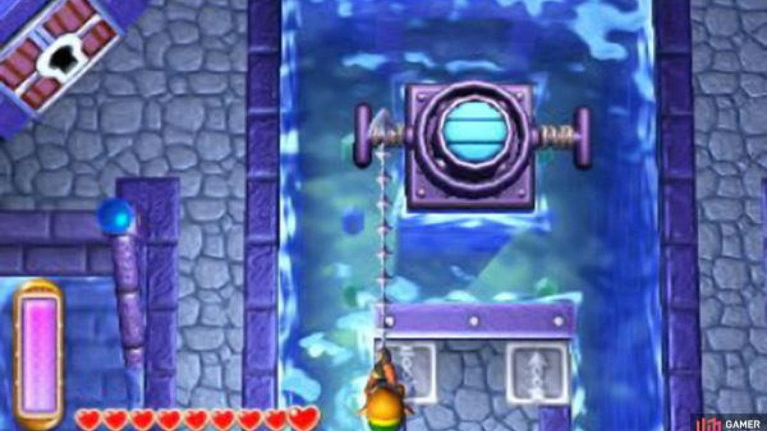 Pull the left-hand lever with your hookshot to lower the water level and pull the right-hand leverl to raise the water level in any given room.