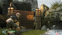 Push the gate back using axe throws to find a coffin behind it.