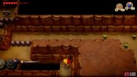 use the Bomb and Bow to destroy the stone then Hookshot your way across,
