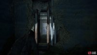 Slide through the gap in the wall to get further