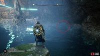 Dive under the water on the left side and swim under the rock to reach the other side.