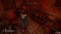 You’ll find the chest on the southern side of the building.