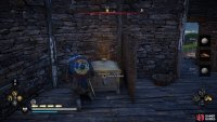 You’ll find the chest in a small building within the camp.