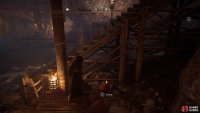 Take a fire pot from beneath the nearby canopy and place it near the barricade.