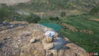 Next, pick the roundest of the two flat rocks and place it on top.
