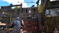 Climb up the southern wall, kick the shield down and open the gate.