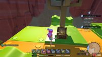 The treasure chest is under a fake tree at the top of the toy building.