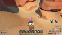 The chest is covered by some sand next to a rock pillar.