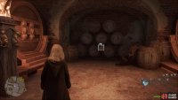 At the bottom of the spiral stairs are barrels next to the Hufflepuff Common Room.