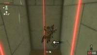 Walk into the lasers to drop down below