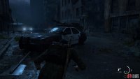 Hide behind this car and enter the room on the right