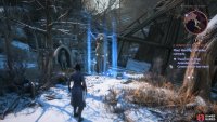 Find the statue between two run-down huts,