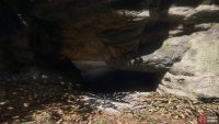 head through the rocks until you find a hole near the ground and crawl through,