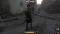 You’ll find Samuel, dressed in green, walking nearby the tavern.