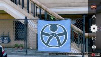 Look for this blue banner hanging on the fence and snap a photo of it.