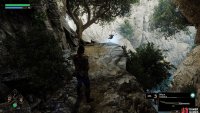 The Crow is on the edge of the cliff to the right of the bridge.