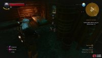Mikula is hiding - poorly - behind some barrels in a hut,